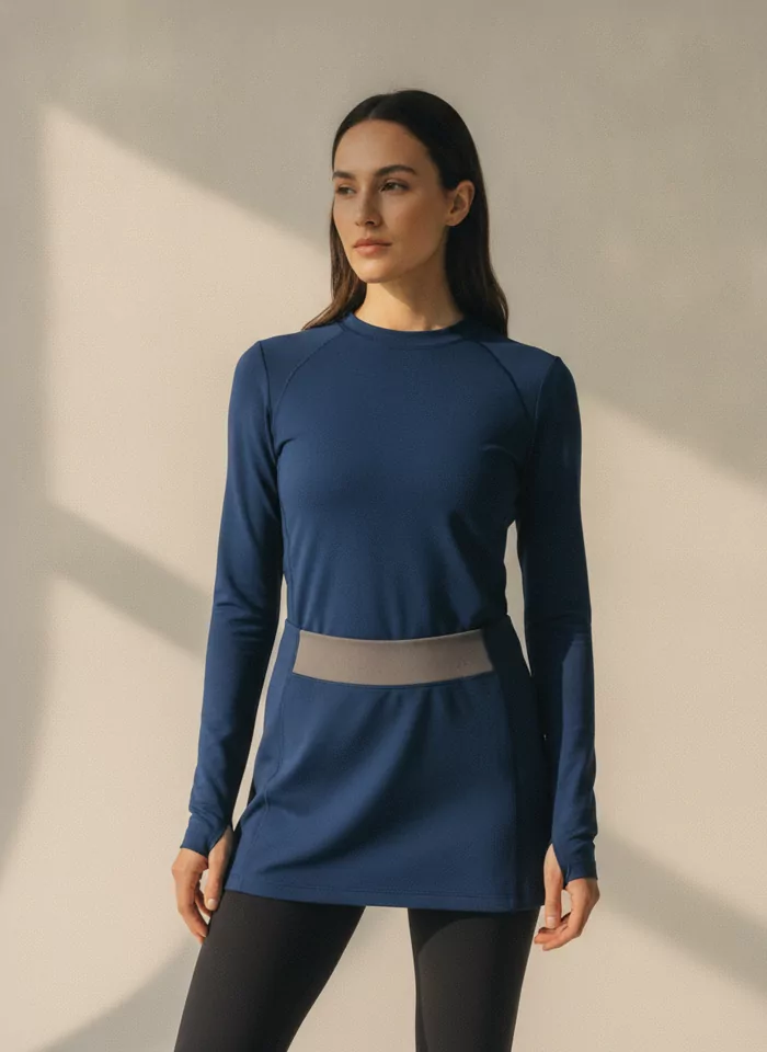Longline training top in deep blue, worn over black leggings